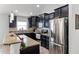 Updated kitchen with dark wood cabinets, stainless steel appliances, and granite countertops at 2213 Grantham Ave, Davenport, FL 33837
