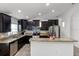 Modern kitchen featuring dark cabinets, stainless steel appliances, and a granite countertop island at 2213 Grantham Ave, Davenport, FL 33837