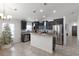 Modern kitchen with dark wood cabinetry, stainless steel appliances, and granite countertops at 2213 Grantham Ave, Davenport, FL 33837