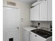 Laundry room with washer, dryer, and upper cabinets for storage at 2213 Grantham Ave, Davenport, FL 33837