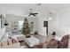Festive living room with a large sectional sofa, Christmas decor, and ceiling fan at 2213 Grantham Ave, Davenport, FL 33837