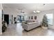 Spacious living room with large sectional sofa, ceiling fan, and tiled floor at 2213 Grantham Ave, Davenport, FL 33837