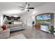 Open-concept living room with a sectional, wood accent wall, and view of the kitchen at 2213 Grantham Ave, Davenport, FL 33837
