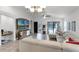 Living area with a sectional sofa, wood accent wall, and view of the backyard at 2213 Grantham Ave, Davenport, FL 33837