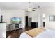 Spacious main bedroom with wood floors, ceiling fan, and ensuite bathroom at 2213 Grantham Ave, Davenport, FL 33837