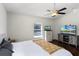 Main bedroom with a ceiling fan, wood-look floors, and a view of the pool outside at 2213 Grantham Ave, Davenport, FL 33837