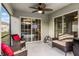 Relaxing screened patio with wicker seating and ceiling fan at 2213 Grantham Ave, Davenport, FL 33837