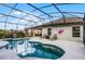 Screened-in pool with a tranquil waterfall, perfect for relaxation at 2213 Grantham Ave, Davenport, FL 33837