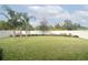 Spacious backyard with grassy lawn, trees, and privacy fence at 2393 Jernigan Loop, Kissimmee, FL 34746