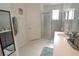 Double vanity bathroom with walk-in shower and modern fixtures at 2393 Jernigan Loop, Kissimmee, FL 34746
