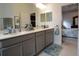 Double vanity bathroom with walk-in shower and modern fixtures at 2393 Jernigan Loop, Kissimmee, FL 34746