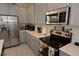 Stainless steel appliances and white countertops in a modern kitchen setting at 2393 Jernigan Loop, Kissimmee, FL 34746