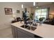Kitchen island with double sink, overlooking living room and backyard at 2393 Jernigan Loop, Kissimmee, FL 34746