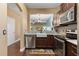 Kitchen with stainless steel appliances, a farmhouse sink, and wood cabinetry at 255 Cambria Ave, Davenport, FL 33897