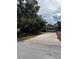 Ranch-style home with a two-car garage and mature trees in the front yard at 2680 Palmetto Rd, Mount Dora, FL 32757