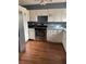 Kitchen with white cabinets, stainless steel appliances, and laminate flooring at 2680 Palmetto Rd, Mount Dora, FL 32757