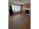 Living room featuring hardwood floors and a brick fireplace at 2680 Palmetto Rd, Mount Dora, FL 32757