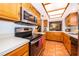 Well-equipped kitchen with a stainless steel microwave, stovetop, and range hood at 3048 Pigeon Hawk Ct, Orlando, FL 32829