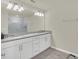 Double vanity bathroom with granite countertop and large mirror at 3780 Plainview Dr, Orlando, FL 32824