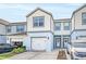 Two-story townhome with white double garage doors at 3780 Plainview Dr, Orlando, FL 32824