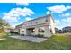 View of a two-story home's exterior and paved patio at 488 Sapphire Dr, Davenport, FL 33837