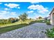 Spacious backyard with a paver patio and a grassy slope at 488 Sapphire Dr, Davenport, FL 33837