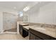 Modern bathroom featuring dual vanities, glass shower, and tiled walls at 488 Sapphire Dr, Davenport, FL 33837
