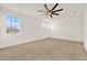 Spacious bedroom with large window, ceiling fan, and neutral carpet at 488 Sapphire Dr, Davenport, FL 33837