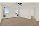 Spacious bedroom with carpet, ceiling fan, and two large windows at 488 Sapphire Dr, Davenport, FL 33837