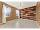 Dining room with tile floors and a rustic wood accent wall at 488 Sapphire Dr, Davenport, FL 33837