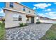 Backyard view of a two-story home with a paver patio at 488 Sapphire Dr, Davenport, FL 33837