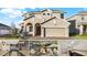 Two-story house with a three-car garage and a brick paver driveway at 488 Sapphire Dr, Davenport, FL 33837