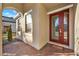 Red front door with glass panels and brick walkway at 488 Sapphire Dr, Davenport, FL 33837