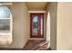 Red front door with glass panels and brick walkway at 488 Sapphire Dr, Davenport, FL 33837