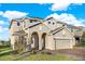 Two-story home with a welcoming front entrance and attached garage at 488 Sapphire Dr, Davenport, FL 33837