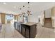 Open kitchen and dining area with dark wood cabinets and an island at 488 Sapphire Dr, Davenport, FL 33837