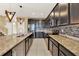 Modern kitchen with dark wood cabinetry, granite countertops, and stainless steel appliances at 488 Sapphire Dr, Davenport, FL 33837