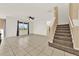 Living room with tile floors and staircase at 488 Sapphire Dr, Davenport, FL 33837