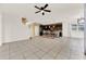 Open living room with tile floors and kitchen island at 488 Sapphire Dr, Davenport, FL 33837