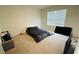 Bedroom with carpeted floor, bed, and large window with blinds at 811 Turner Ln, Winter Haven, FL 33881