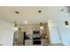 Modern kitchen with gray cabinets, granite countertops, and stainless steel appliances at 811 Turner Ln, Winter Haven, FL 33881