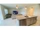 Kitchen with island, granite countertops, stainless steel dishwasher, and living room view at 811 Turner Ln, Winter Haven, FL 33881