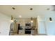 Modern kitchen with gray cabinets, granite countertops, and stainless steel appliances at 811 Turner Ln, Winter Haven, FL 33881