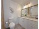 Bathroom featuring double vanity, white cabinetry, and modern fixtures at 3258 Cranston St, Deltona, FL 32738