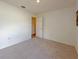 Simple bedroom with neutral-toned carpet and plenty of natural light at 3258 Cranston St, Deltona, FL 32738