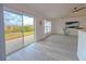 Living room with sliding glass doors leading to the backyard and wood-look floors at 3258 Cranston St, Deltona, FL 32738