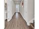 Hallway with wood-look floors and access to other rooms at 1128 Sugarwood St, Davenport, FL 33837