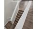 Modern stairs with white railings and wood flooring at 1128 Sugarwood St, Davenport, FL 33837