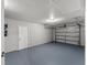 Clean and spacious garage with an automatic garage door and painted floor at 14109 Newcomb Ave, Orlando, FL 32826