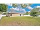 View of the backyard with green grass and trees at 3081 Cloverdale St, Deltona, FL 32738